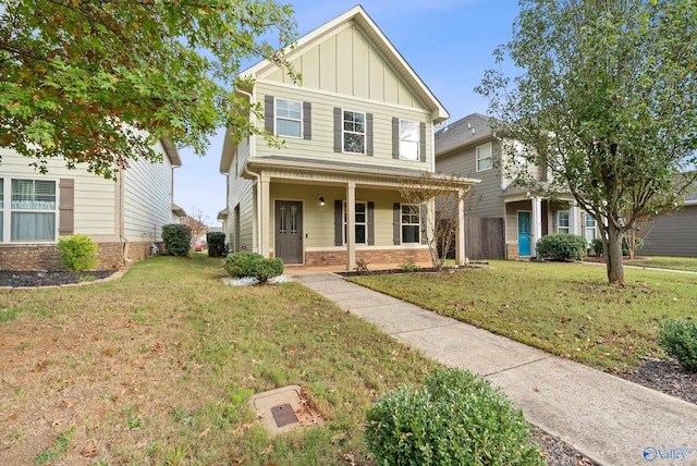 view of front of house with a porch and a front yard