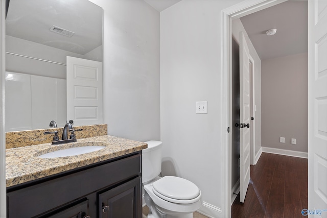 bathroom featuring hardwood / wood-style floors, vanity, and toilet