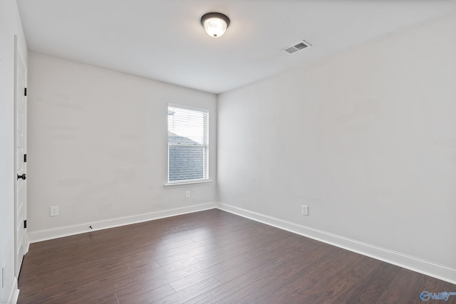 spare room with dark hardwood / wood-style flooring