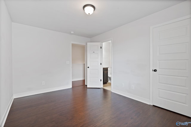 empty room with dark hardwood / wood-style flooring