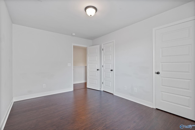 empty room featuring dark wood-type flooring