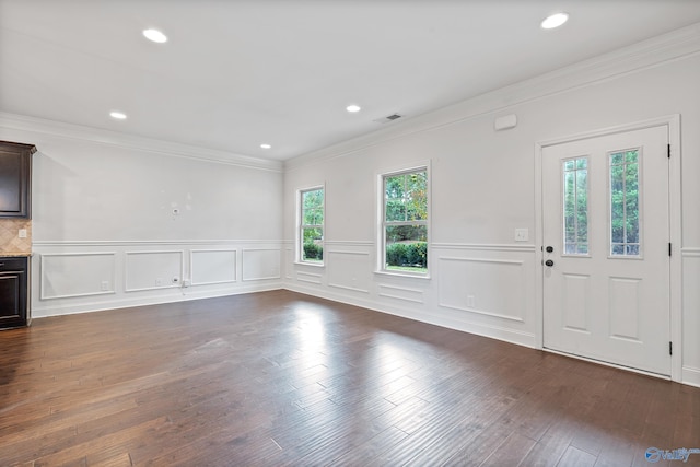 foyer with dark hardwood / wood-style floors and crown molding