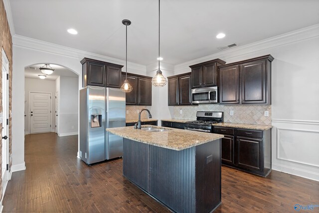 kitchen featuring stainless steel appliances, sink, hanging light fixtures, a kitchen island with sink, and dark hardwood / wood-style flooring