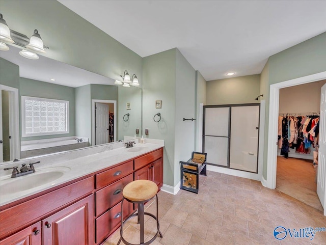 7515 Park Trace Ln SE, Owens Cross Roads, AL 35763 - bathroom with a walk in closet, a shower stall, and double vanity