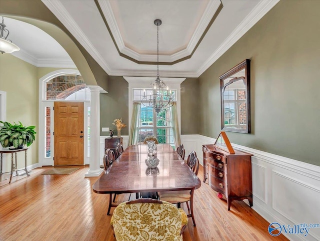7515 Park Trace Ln SE, Owens Cross Roads, AL 35763 - dining area with light wood-type flooring, a raised ceiling, a chandelier, ornate columns, and ornamental molding