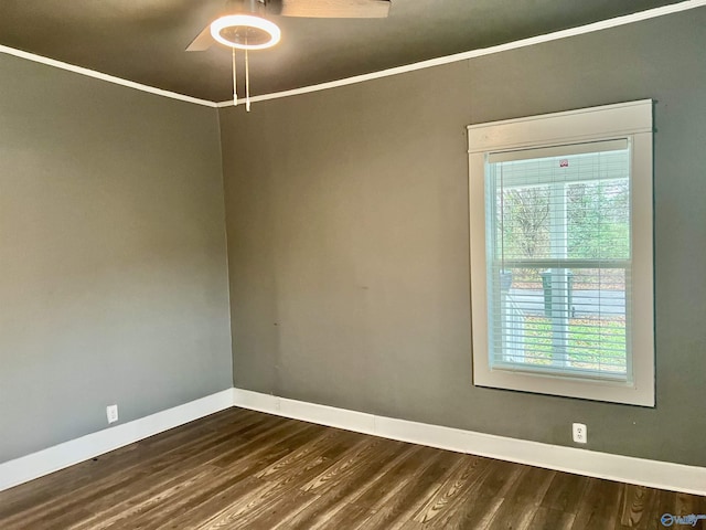 spare room with dark hardwood / wood-style flooring, ceiling fan, and ornamental molding