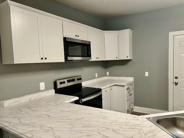 kitchen featuring white cabinetry, sink, and appliances with stainless steel finishes