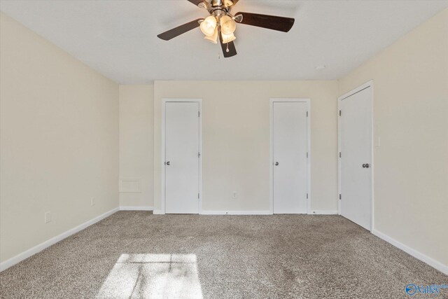 unfurnished bedroom with carpet floors, ceiling fan, and baseboards