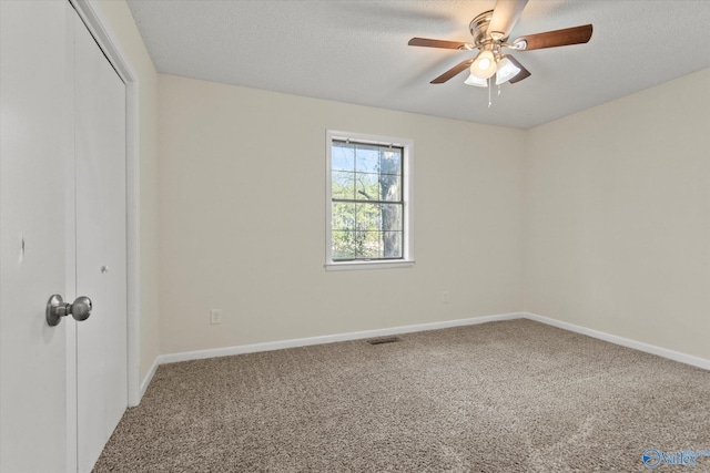 unfurnished bedroom with carpet floors, a closet, visible vents, and a textured ceiling