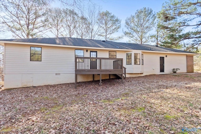 back of house with crawl space and a wooden deck