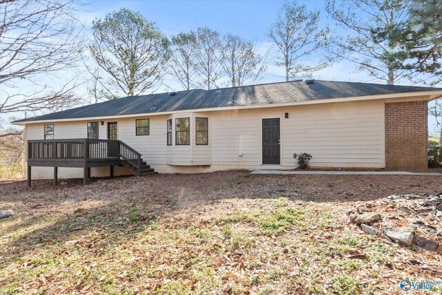 back of house featuring a wooden deck and brick siding