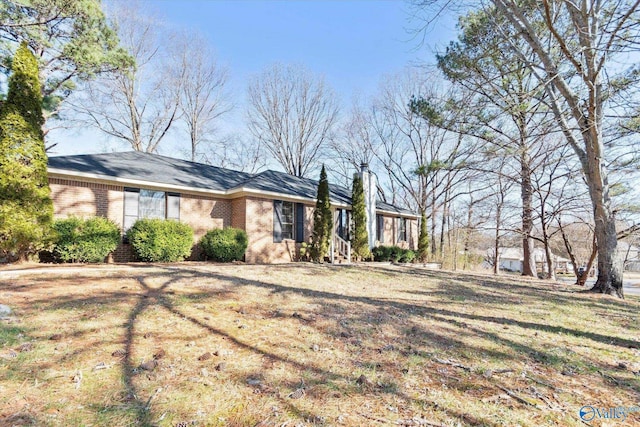 ranch-style house with brick siding and a chimney