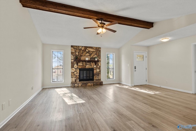 unfurnished living room with a healthy amount of sunlight, light wood-style floors, and a fireplace