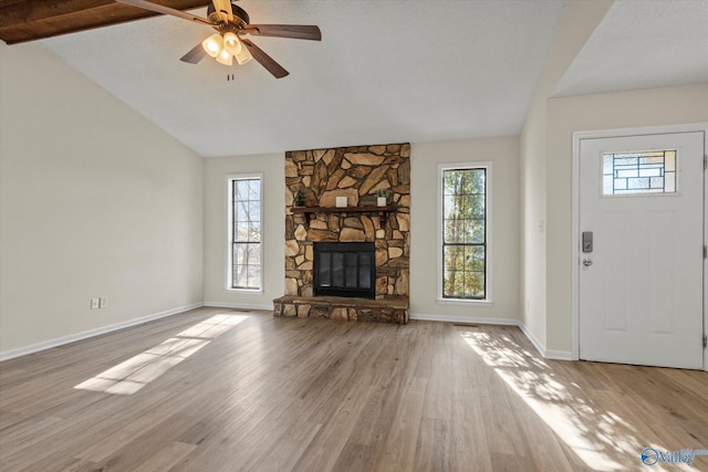 unfurnished living room with a fireplace, plenty of natural light, and wood finished floors