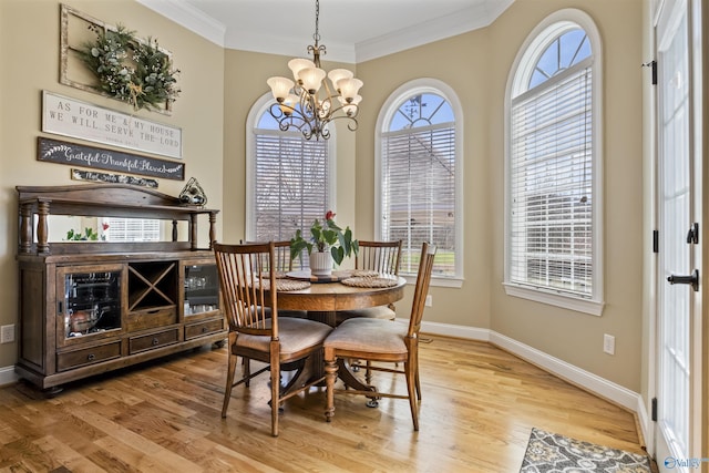 3602 Beason Cove Rd, Steele, AL 35987 - dining area featuring light wood-style floors, baseboards, an inviting chandelier, and crown molding