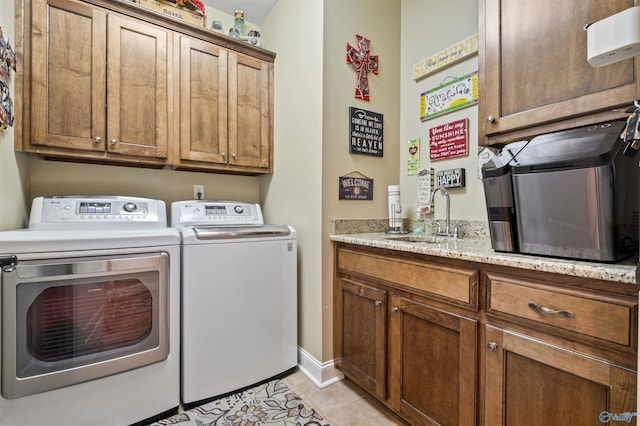 3602 Beason Cove Rd, Steele, AL 35987 - washroom featuring a sink, cabinet space, washing machine and dryer, and light tile patterned flooring