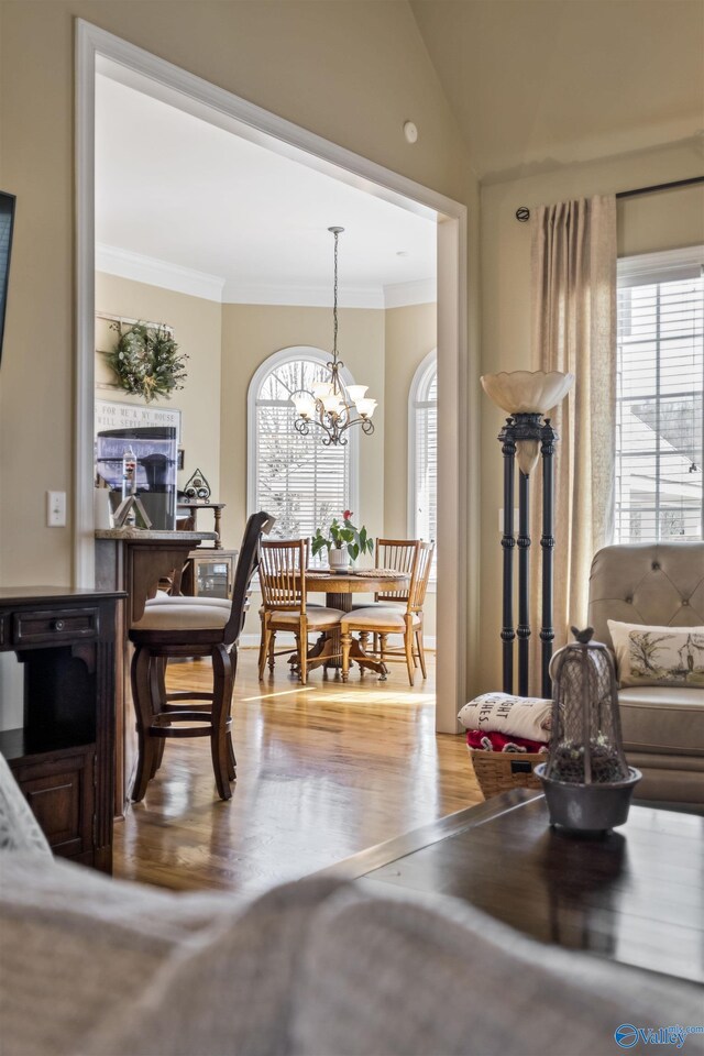 3602 Beason Cove Rd, Steele, AL 35987 - dining area featuring crown molding, wood finished floors, an inviting chandelier, and plenty of natural light