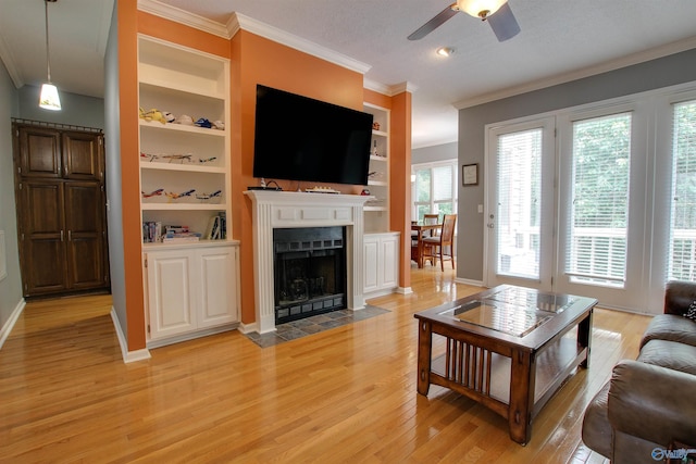 213 Knollridge Cir, Huntsville, AL 35801 - living area featuring light wood finished floors, a ceiling fan, ornamental molding, baseboards, and a fireplace with flush hearth