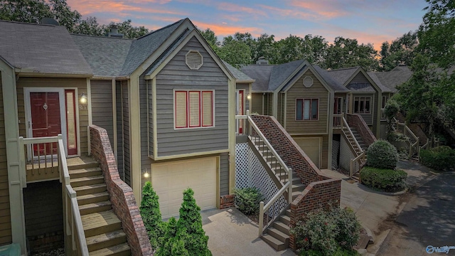 213 Knollridge Cir, Huntsville, AL 35801 - view of front facade featuring stairway, an attached garage, and concrete driveway