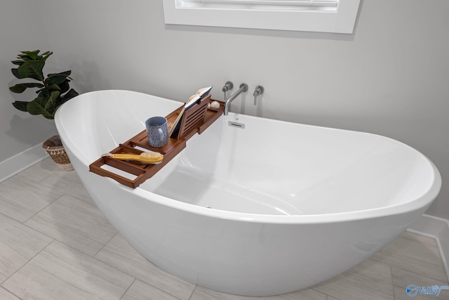 139 Summit Pt, Guntersville, AL 35976 - full bathroom with a freestanding tub, tile patterned flooring, and baseboards