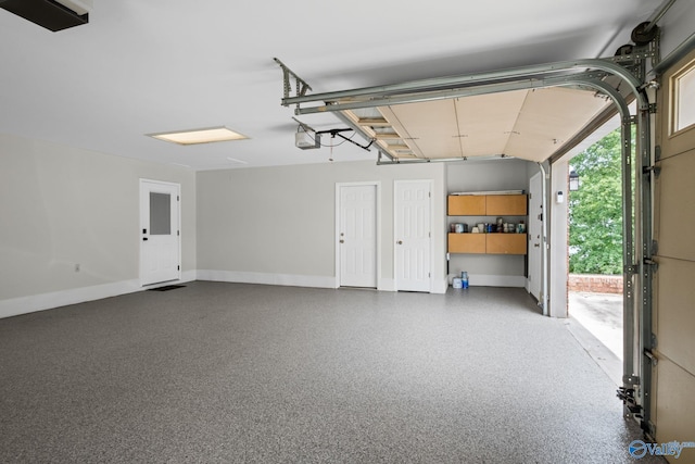 139 Summit Pt, Guntersville, AL 35976 - garage featuring a garage door opener and baseboards