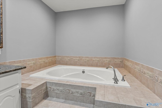 full bath featuring a garden tub and vanity