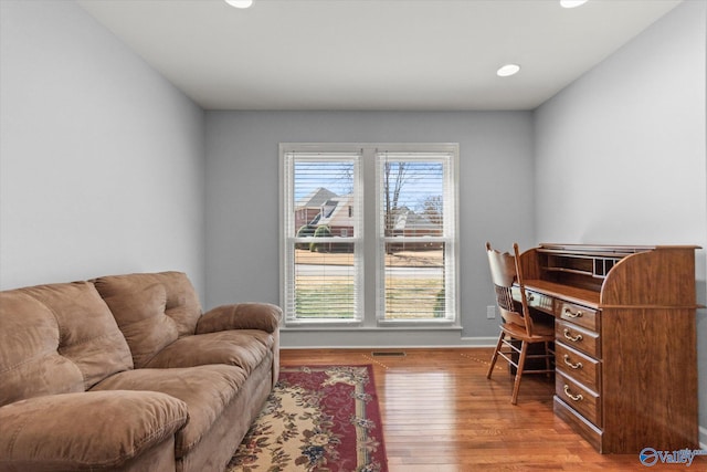 office area with visible vents, baseboards, and hardwood / wood-style floors