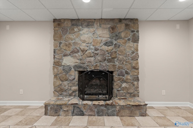 interior details with a drop ceiling and baseboards