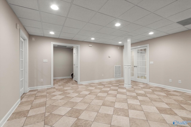 below grade area featuring visible vents, recessed lighting, french doors, a paneled ceiling, and baseboards