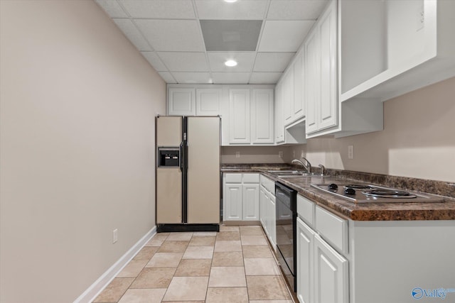 kitchen featuring a sink, white cabinets, white refrigerator with ice dispenser, dishwasher, and dark countertops