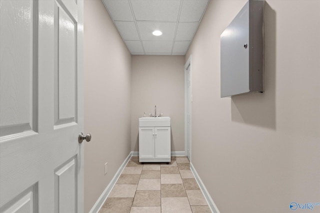 interior space with a sink, baseboards, and recessed lighting