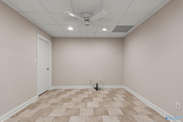 empty room with recessed lighting, a drop ceiling, baseboards, and ceiling fan
