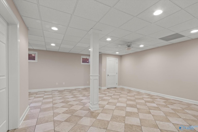 finished basement featuring recessed lighting, baseboards, and a paneled ceiling