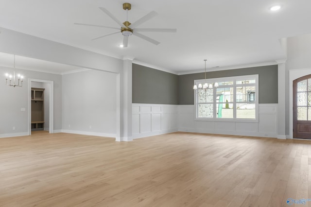 interior space featuring ornamental molding, ceiling fan with notable chandelier, and light hardwood / wood-style flooring