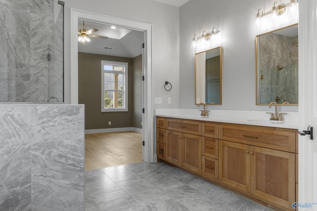 bathroom featuring ceiling fan, vanity, and a shower