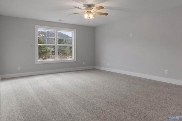 carpeted empty room featuring ceiling fan