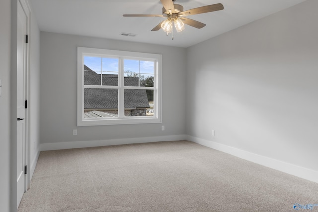 empty room featuring light colored carpet and ceiling fan