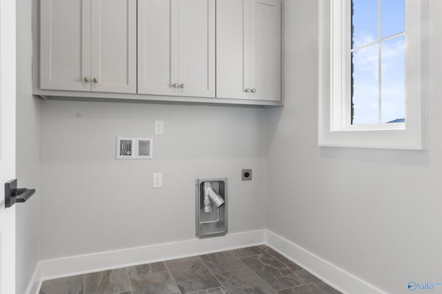 washroom with electric dryer hookup, hookup for a washing machine, and cabinets