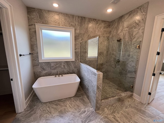 bathroom with shower with separate bathtub