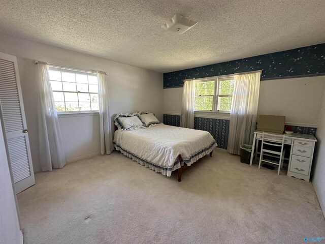 carpeted bedroom with a textured ceiling