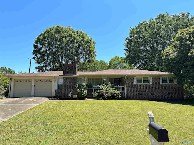 ranch-style house with a garage and a front lawn