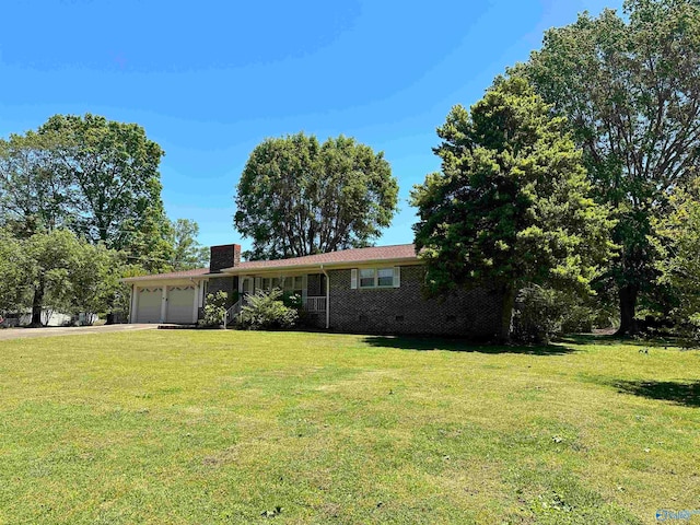 view of front facade with a garage and a front lawn