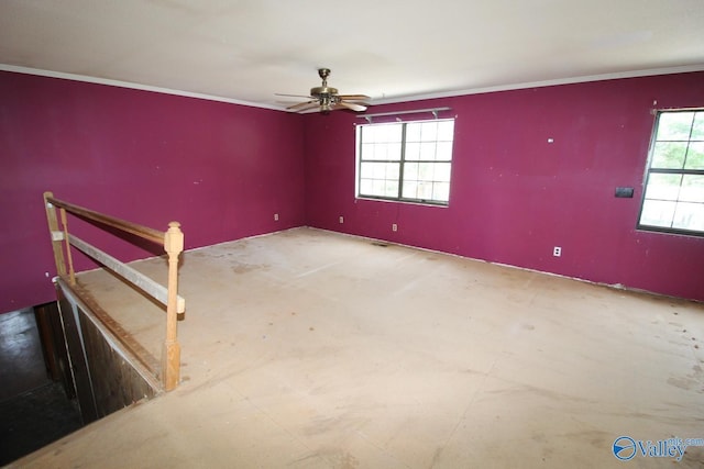 unfurnished room featuring ceiling fan and crown molding