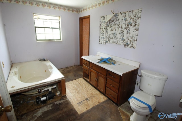 full bath featuring a whirlpool tub, vanity, and toilet