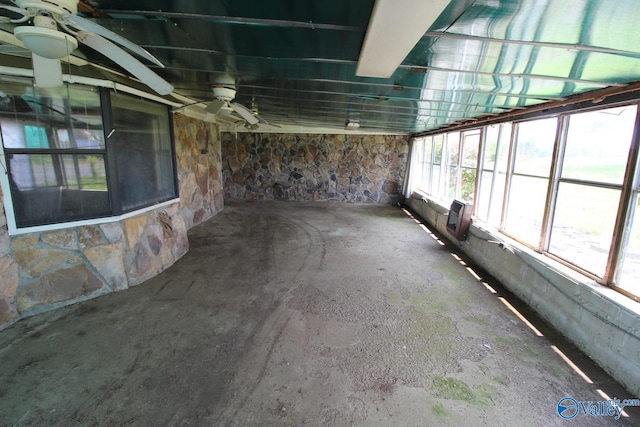 interior space featuring an AC wall unit and unfinished concrete flooring