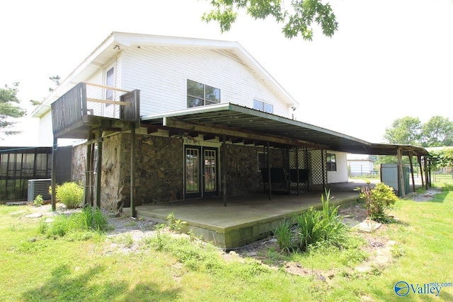 rear view of house featuring central AC, french doors, a patio, and stone siding