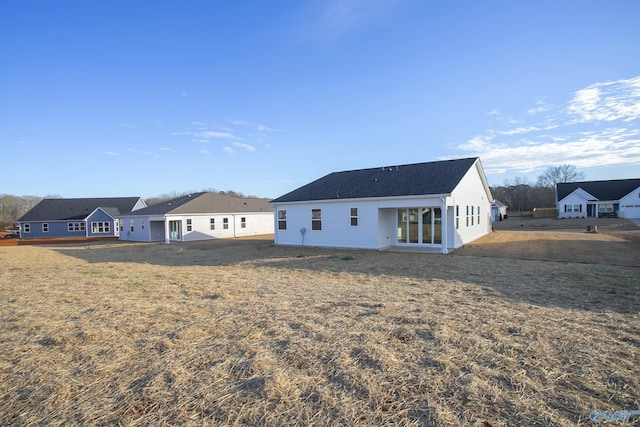 rear view of property with a lawn