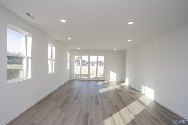 empty room with light hardwood / wood-style floors