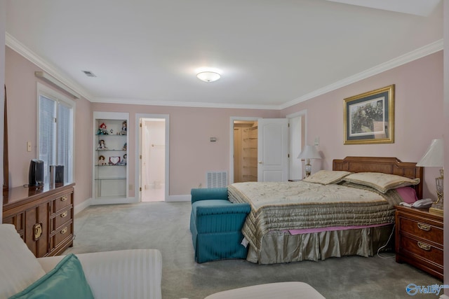 bedroom featuring ornamental molding, light colored carpet, and ensuite bathroom