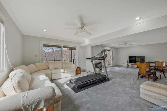 exercise room featuring ornamental molding, carpet floors, and ceiling fan